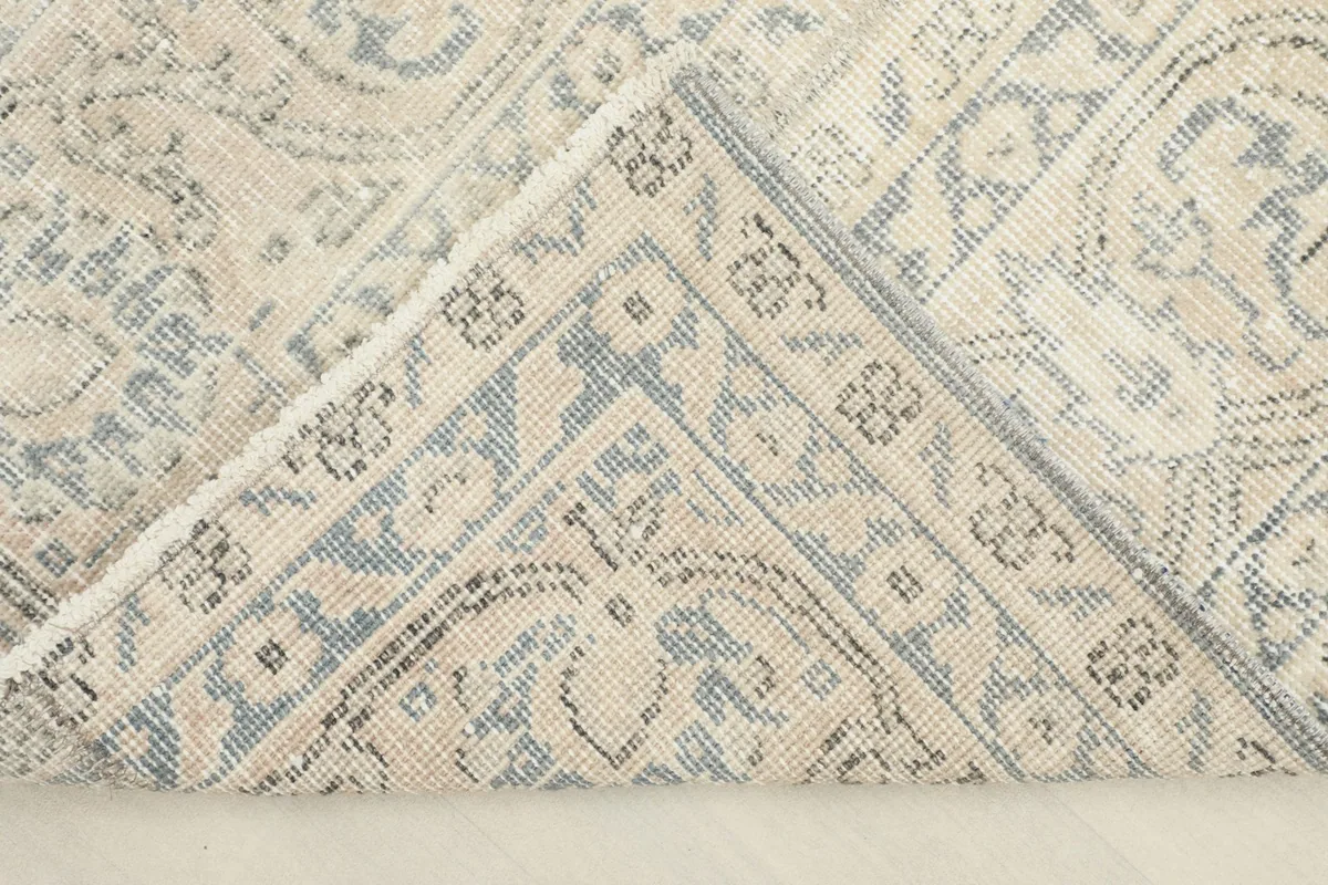 Detailed view of the rug's underside, revealing the hand-knotted construction and cotton foundation.