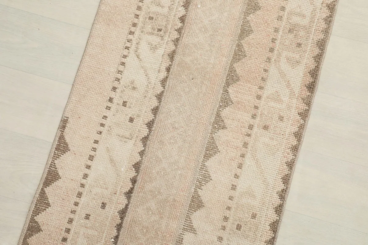 Close-up detail of the striped geometric patterns and texture of the rug