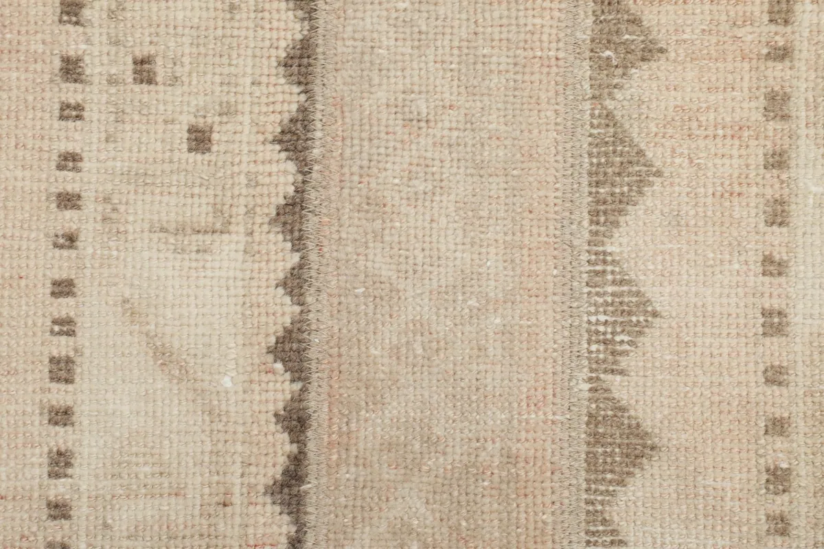 Close-up of the low pile and intricate knotting of the vintage wool rug
