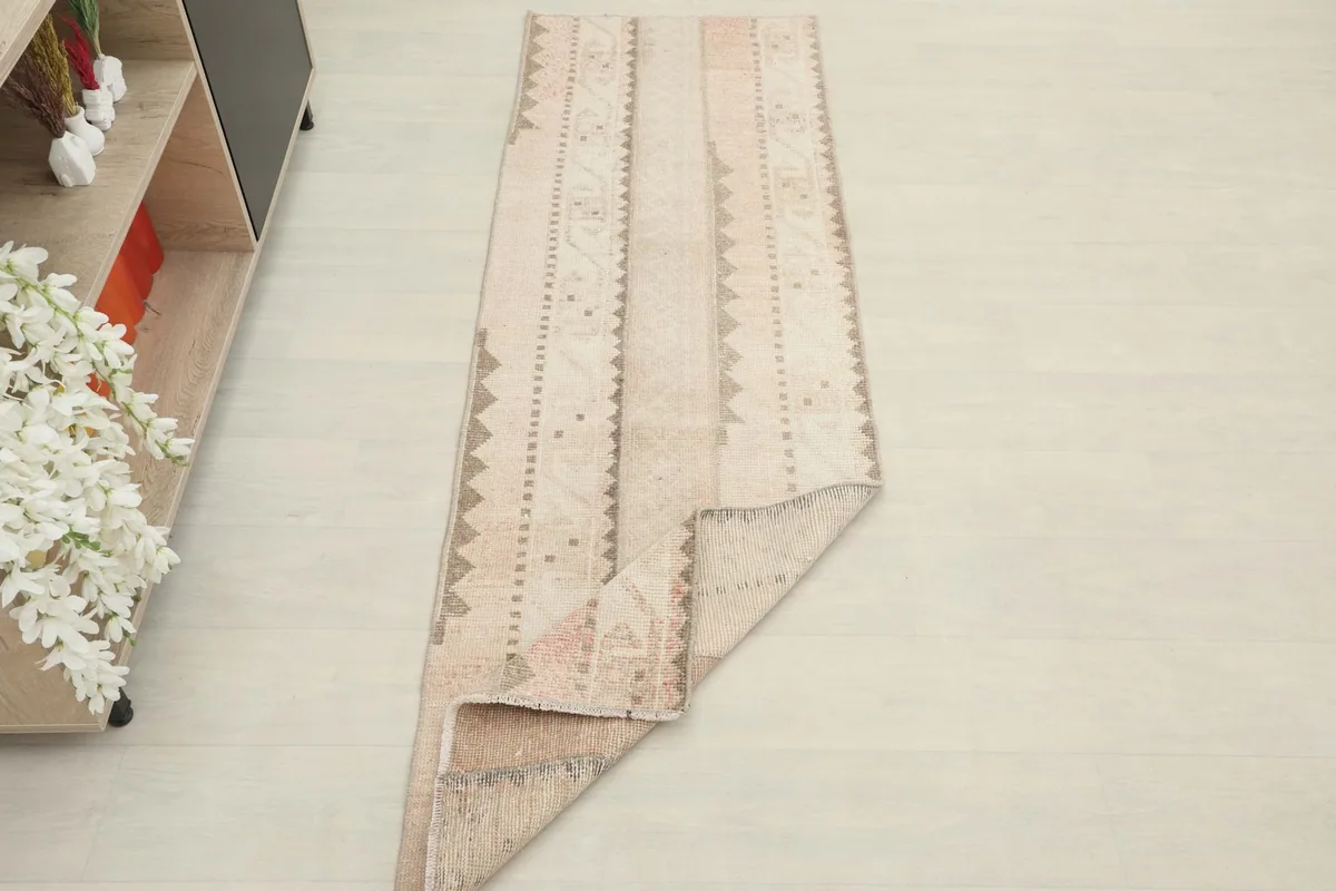 The runner rug partially folded, showcasing its flexibility and full length