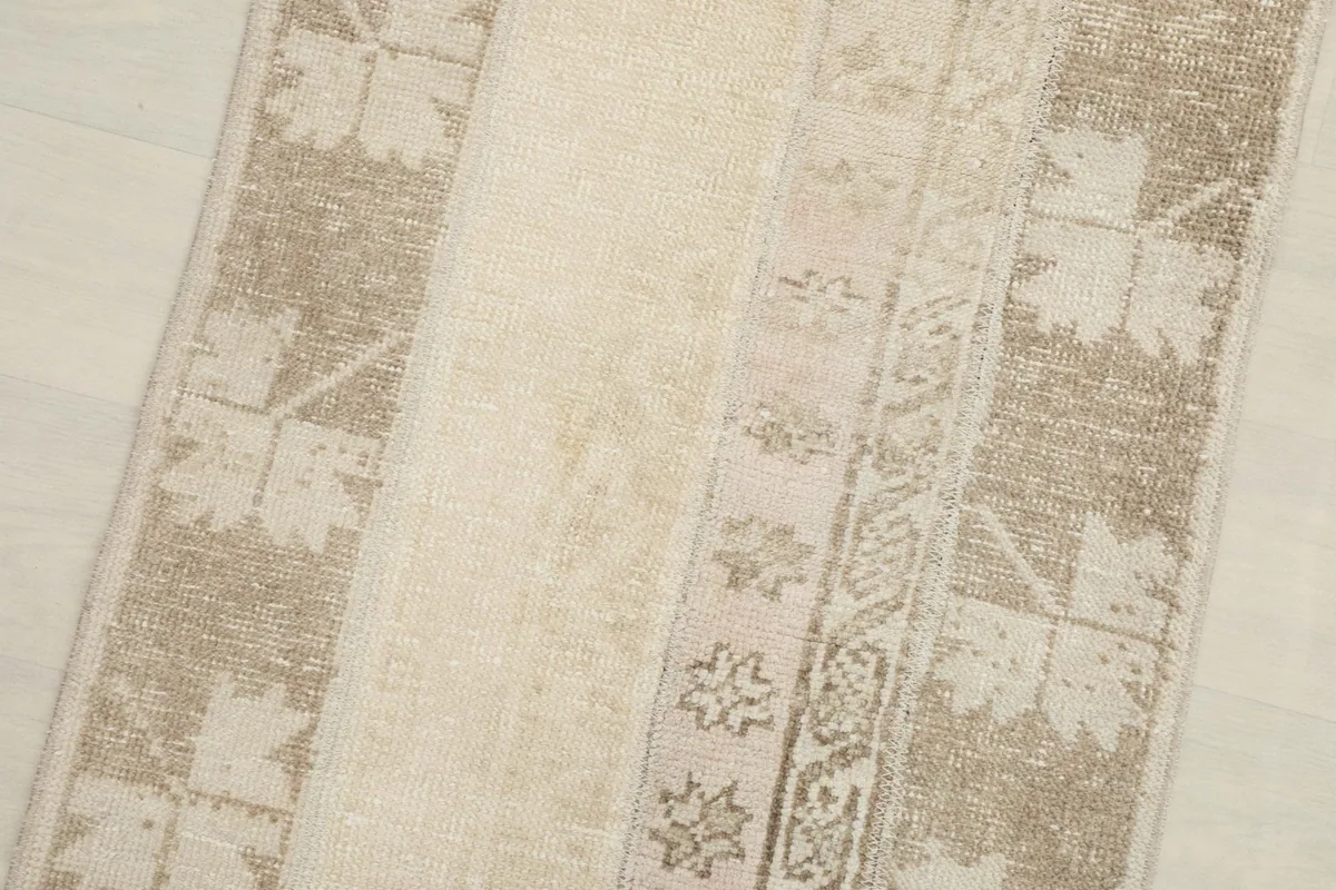 Angled close-up of the rug's center, revealing the different patchwork sections and subtle patterns.