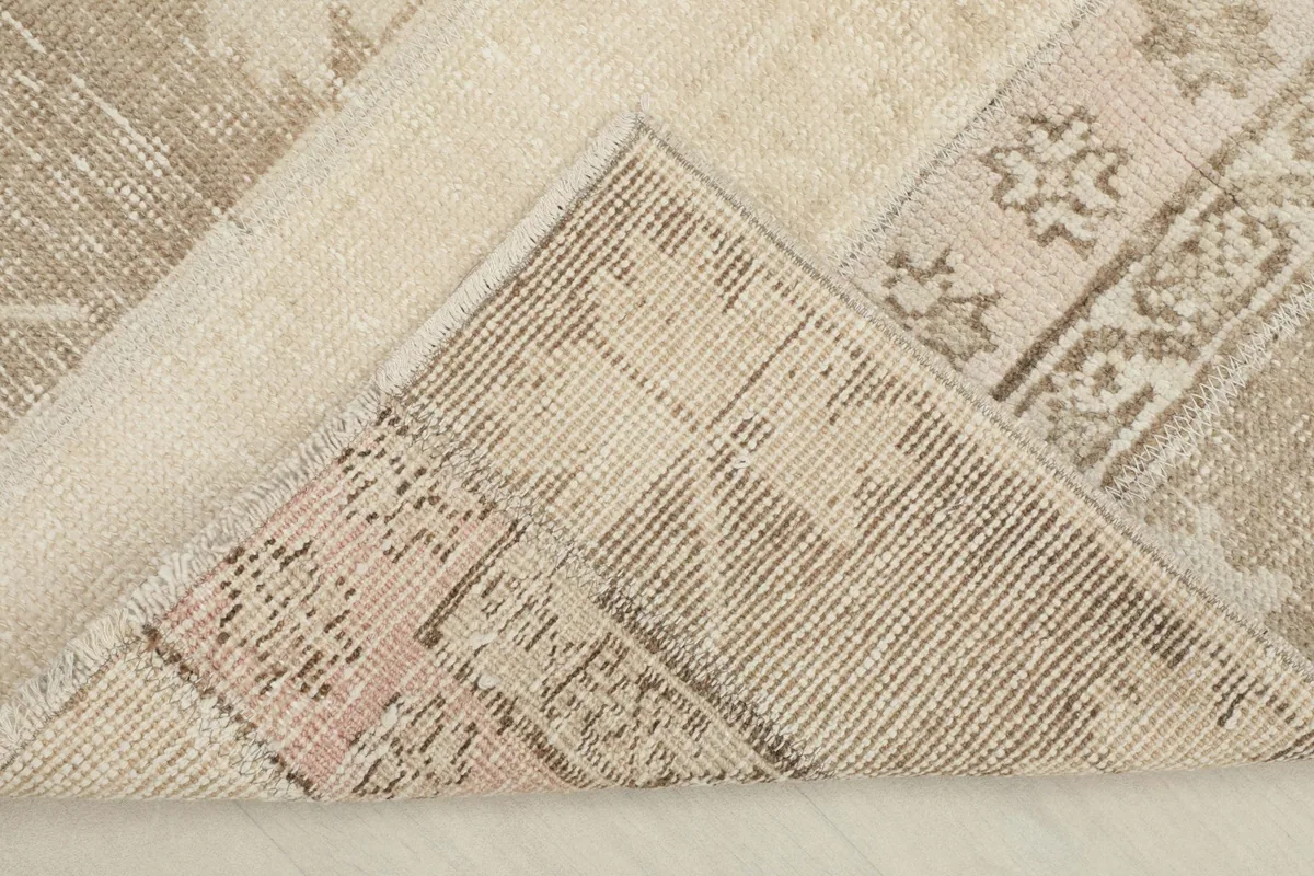 View of the back of the rug, illustrating the hand-knotted construction and cotton foundation.