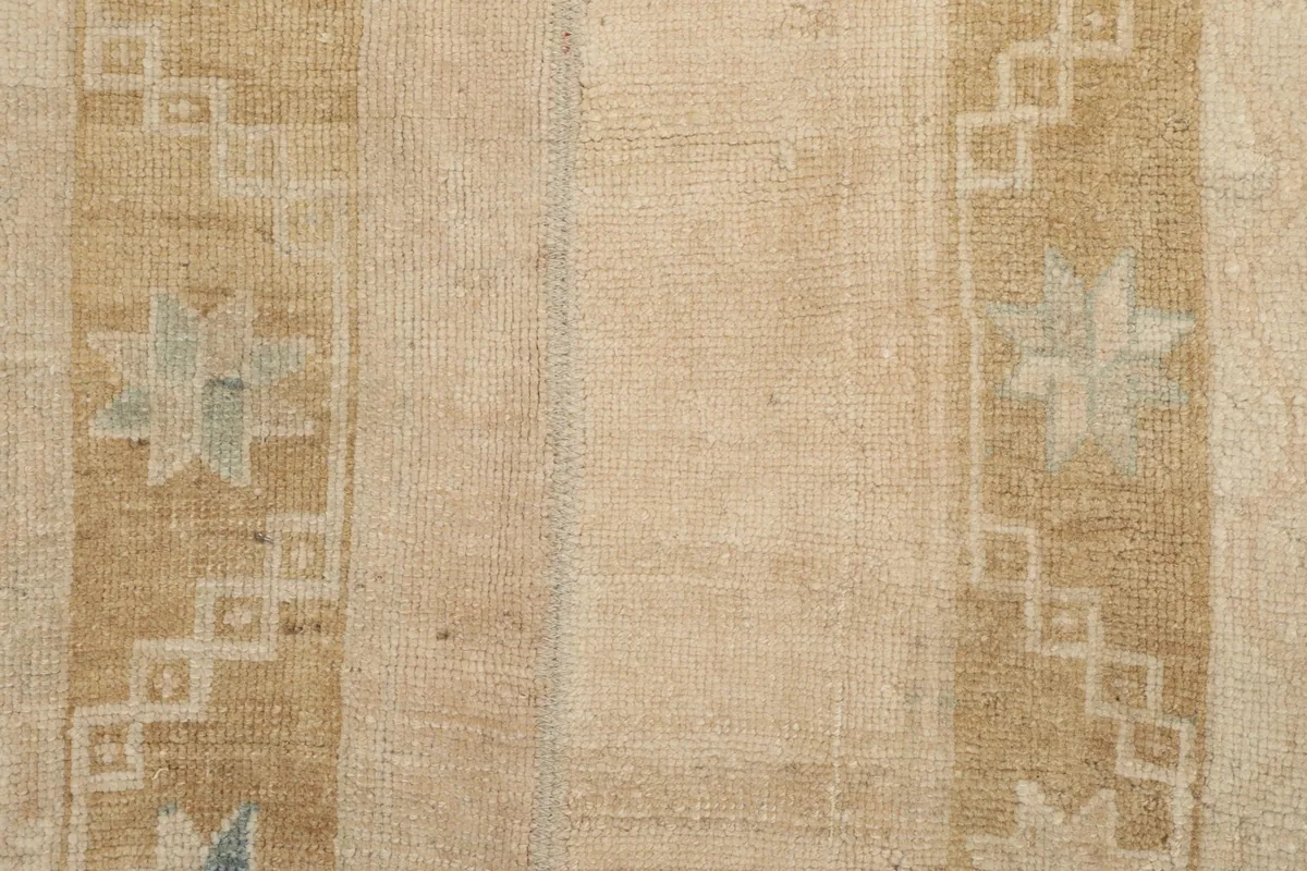 Detailed view of the low wool pile and the intricate geometric patterns.