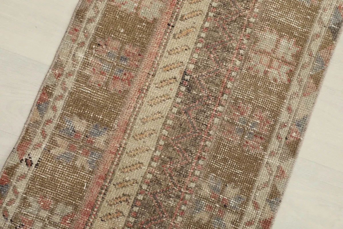 Close-up detail of the rug's center, highlighting the geometric and striped design elements.