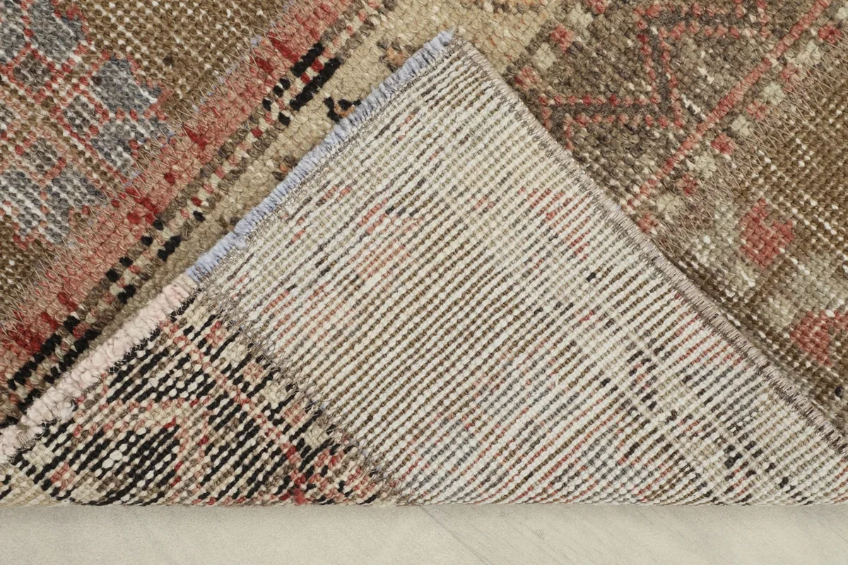 View of the back of the rug, revealing the cotton foundation and hand-knotted construction.