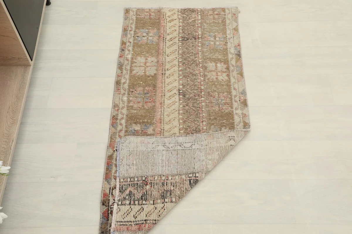 The rug partially folded, illustrating its flexibility and thickness from an overhead perspective.