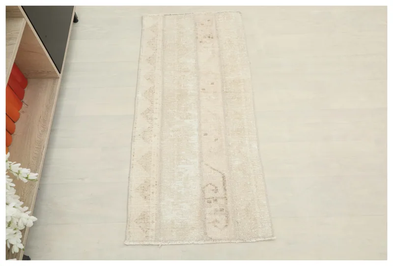 Full top view of the 1'10" x 4'1" cream and beige vintage Anatolian area rug
