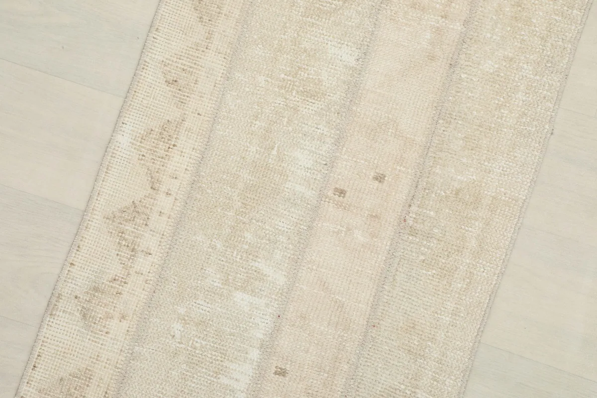 Close-up of the rug's surface, showing the subtle color variations and wool pile
