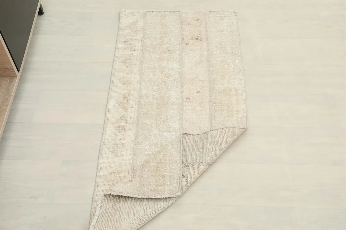 Rug partially folded, demonstrating its flexibility and construction