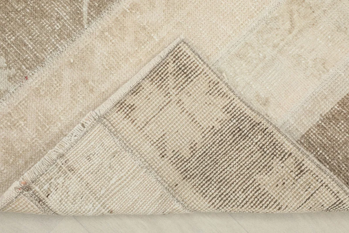 View of the rug's underside, revealing the hand-knotted cotton foundation.