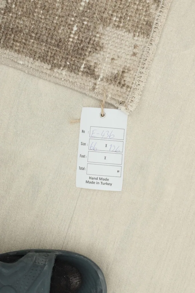 Product tag attached to the rug, displaying size and origin details.