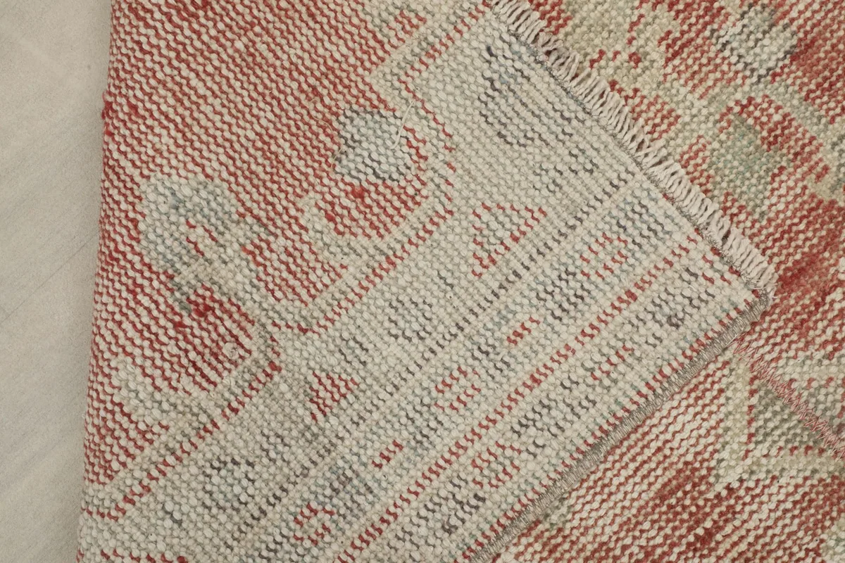 View of the rug's reverse side, revealing the hand-knotted wool on cotton foundation.