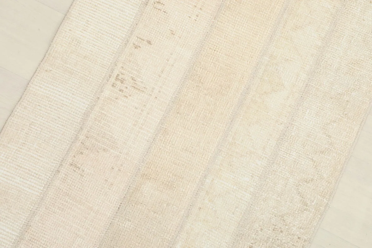 Diagonal close-up showing the varied wool pile and the distinct lines where patchwork sections meet