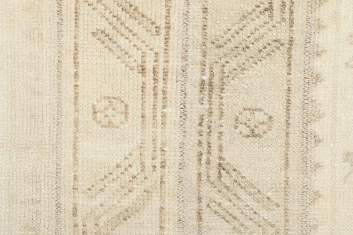 Intricate detail of the hand-knotted patterns and wool pile texture