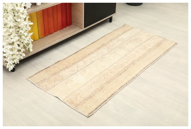 Top view of a 2x4 beige vintage Anatolian rug with geometric patterns on a white background