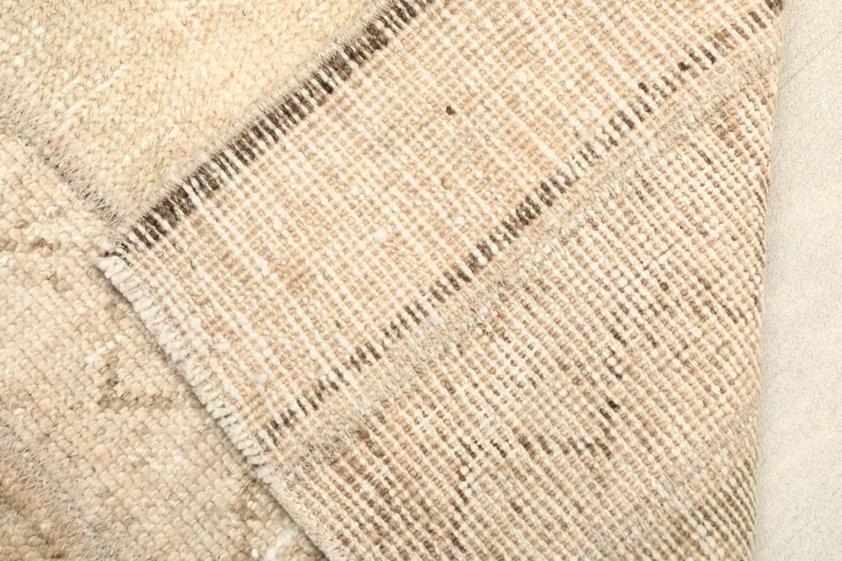 Close-up of the back of the hand-knotted rug, revealing its cotton foundation and craftsmanship