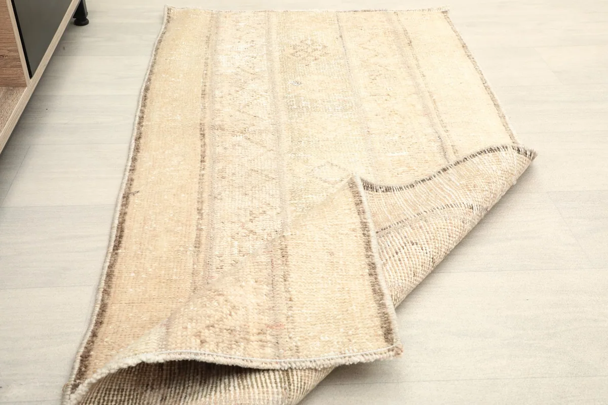 View of the rug folded, showing its flexibility and the reverse side