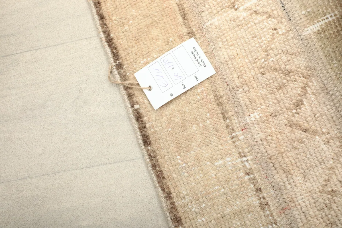 Close-up of the rug's edge with a product tag, indicating its origin and materials