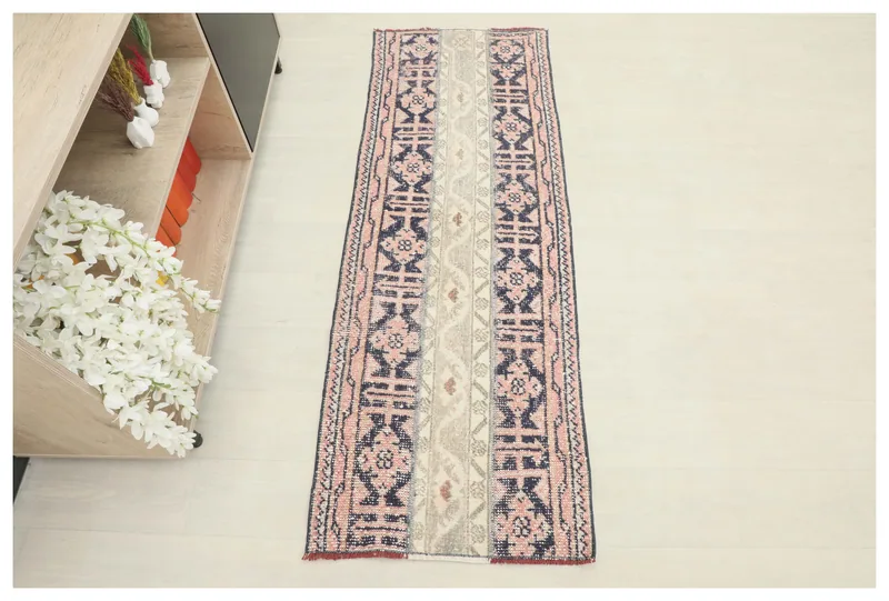 Full overhead view of the 2'0" x 5'8" rose, navy, and beige geometric Anatolian runner rug.