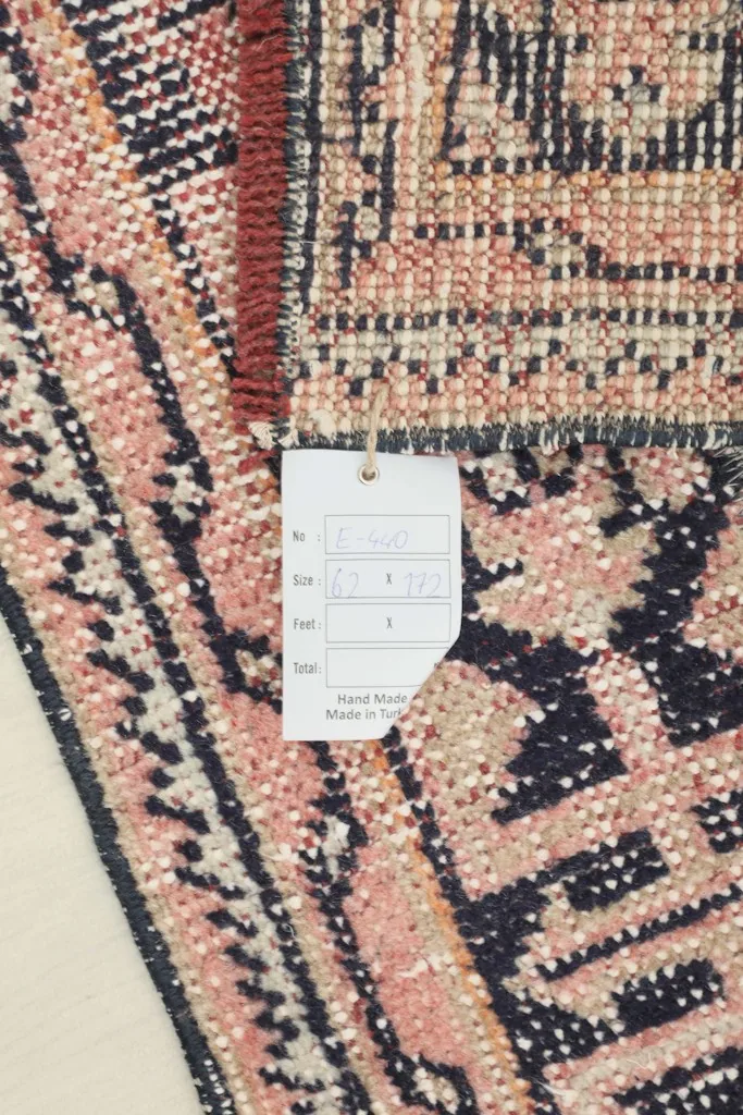 Close-up of the rug's back and edge, with a product tag visible.