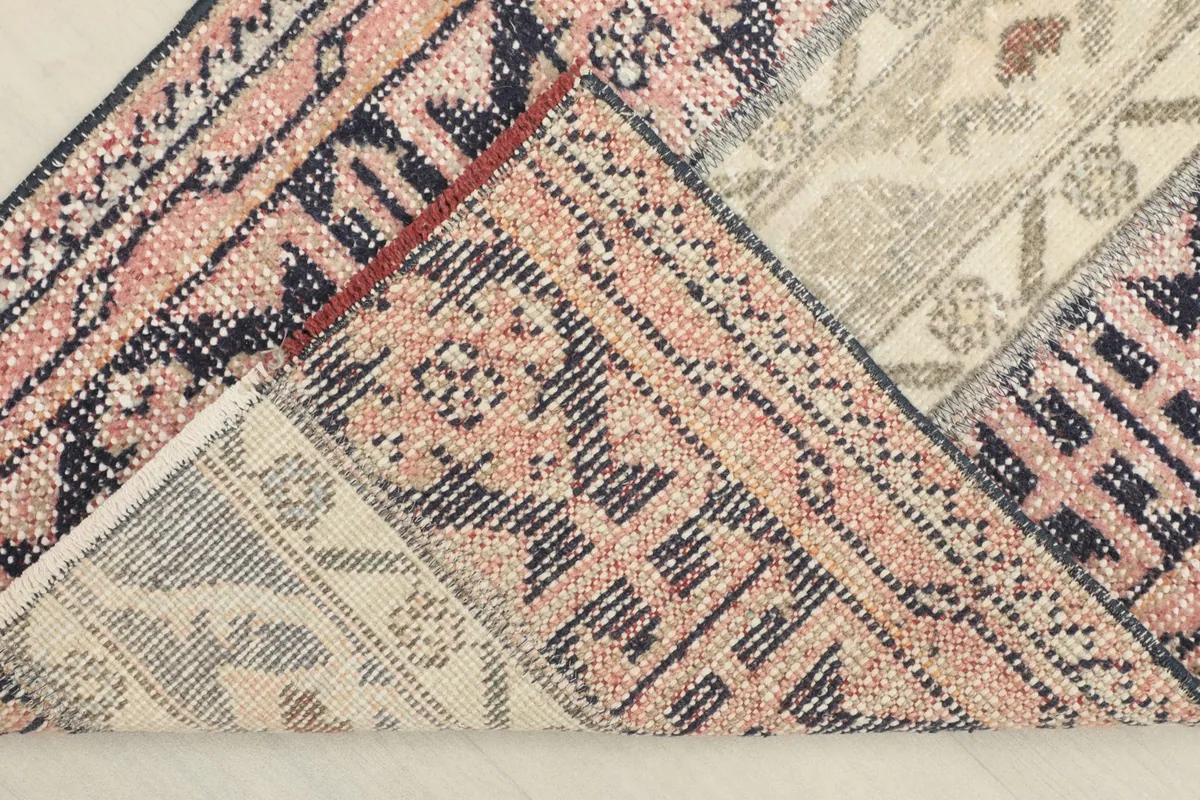 View of the back of the hand-knotted runner, revealing the cotton foundation and knotting.