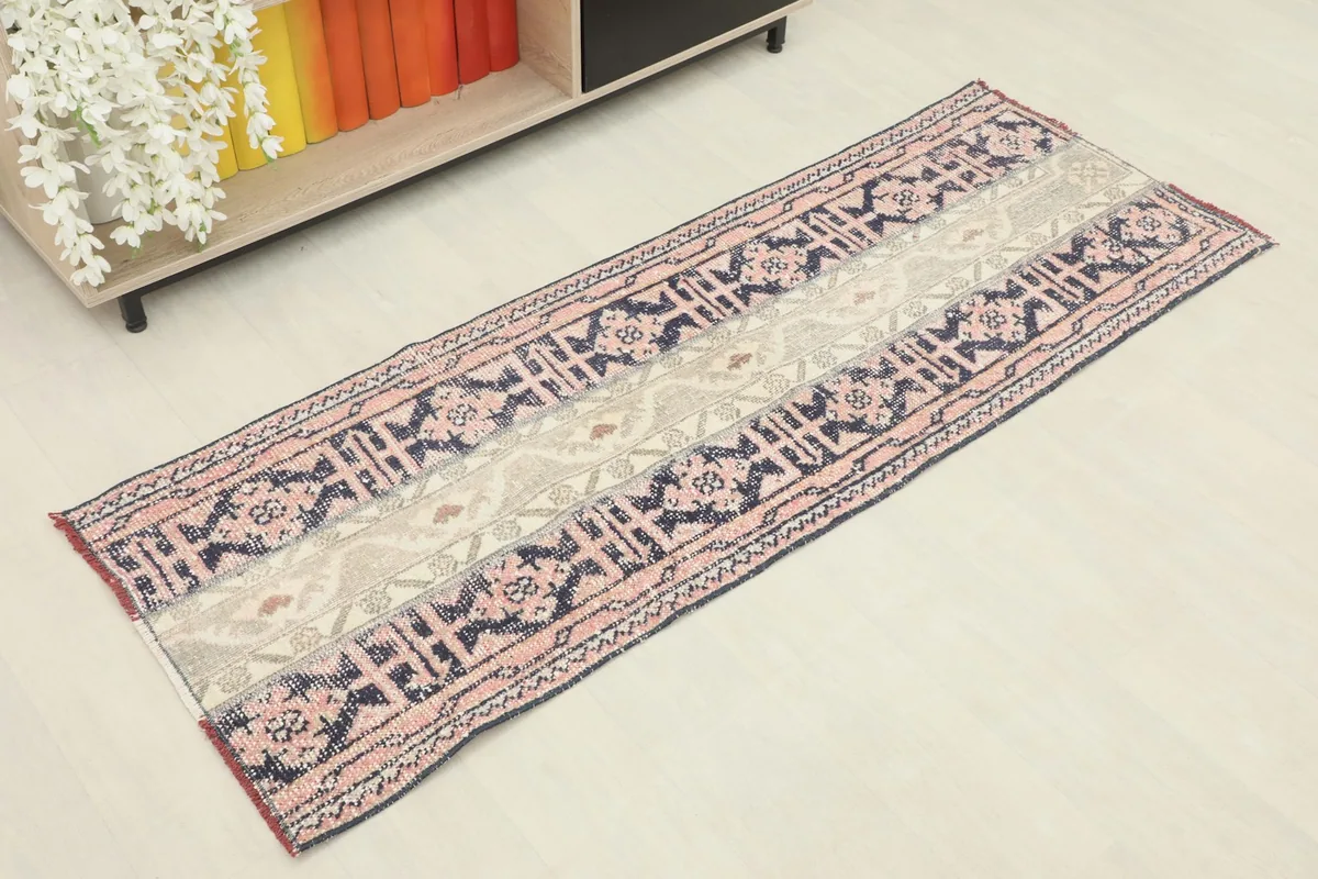 Angled overhead view of the vintage Anatolian runner showing its full length and colors.