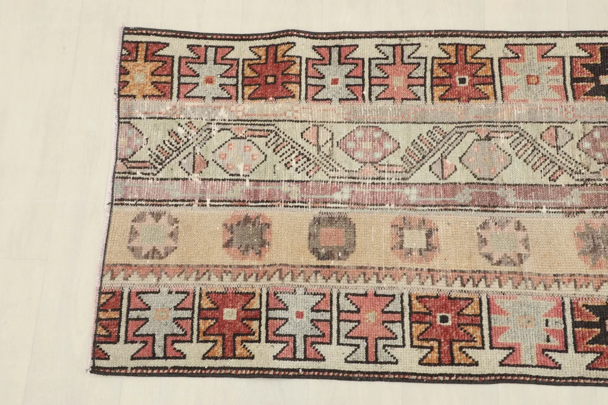 Detailed section of the rug showing varied tribal motifs and color variations