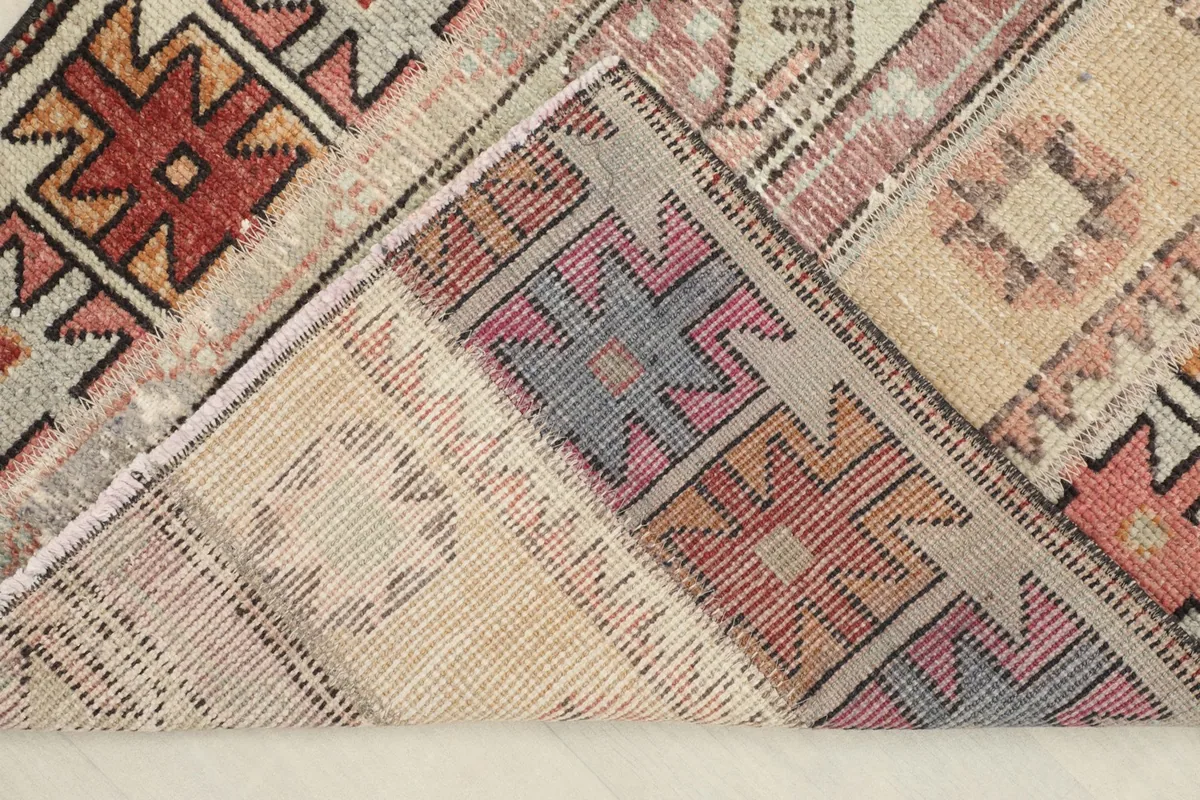 Corner of the rug folded to show the cotton foundation and reverse side of the knots