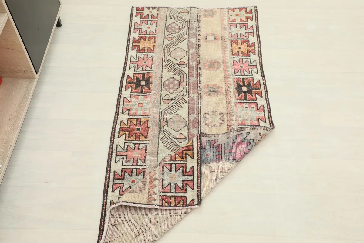 Rug partially folded, demonstrating its flexibility and construction