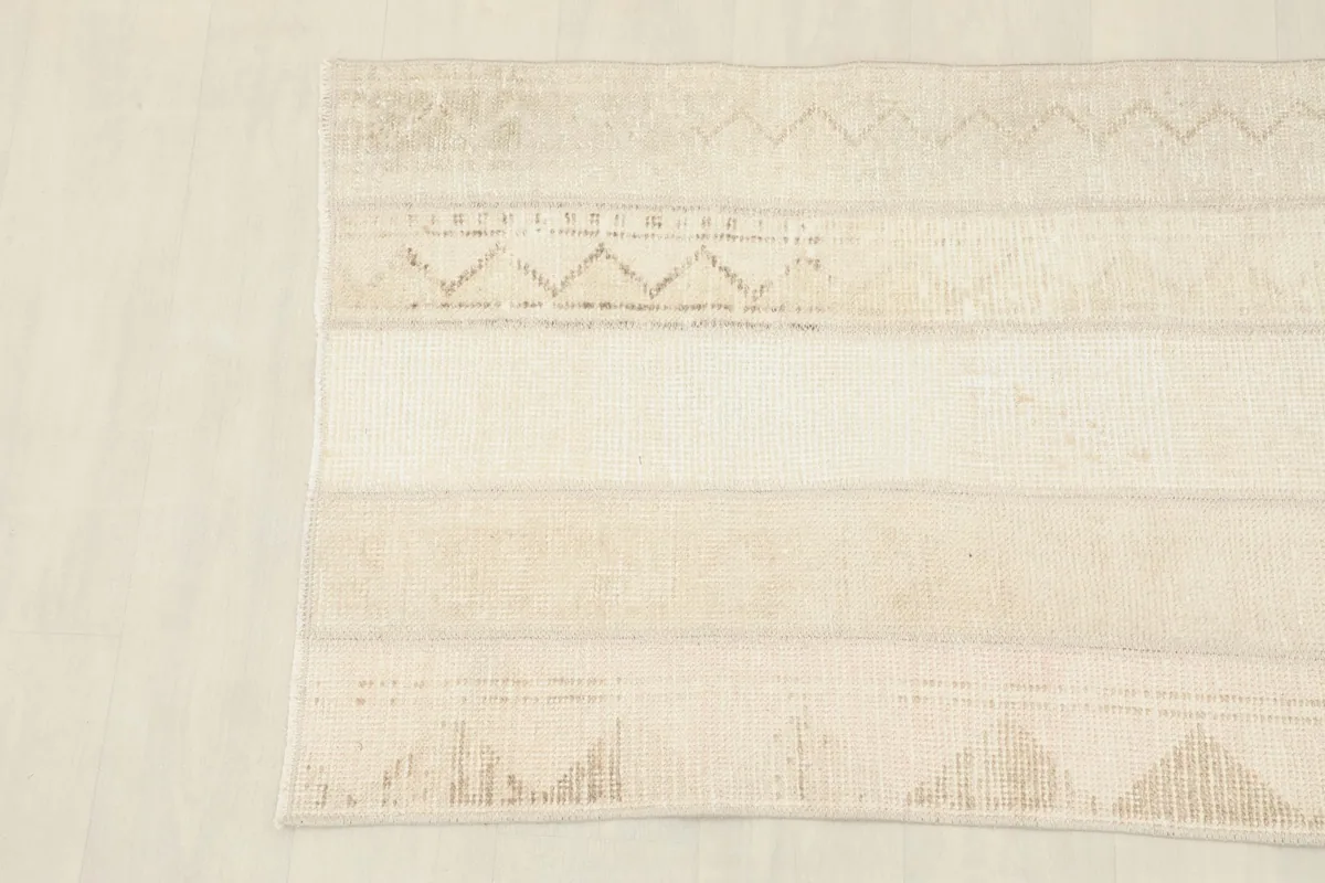 Detail shot showing the subtle geometric patterns within the rug's beige panels