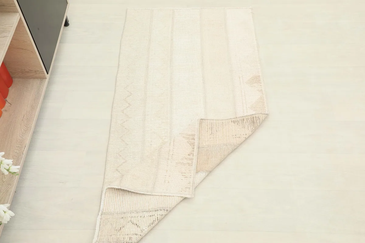 Rug partially folded to show its flexibility and thickness