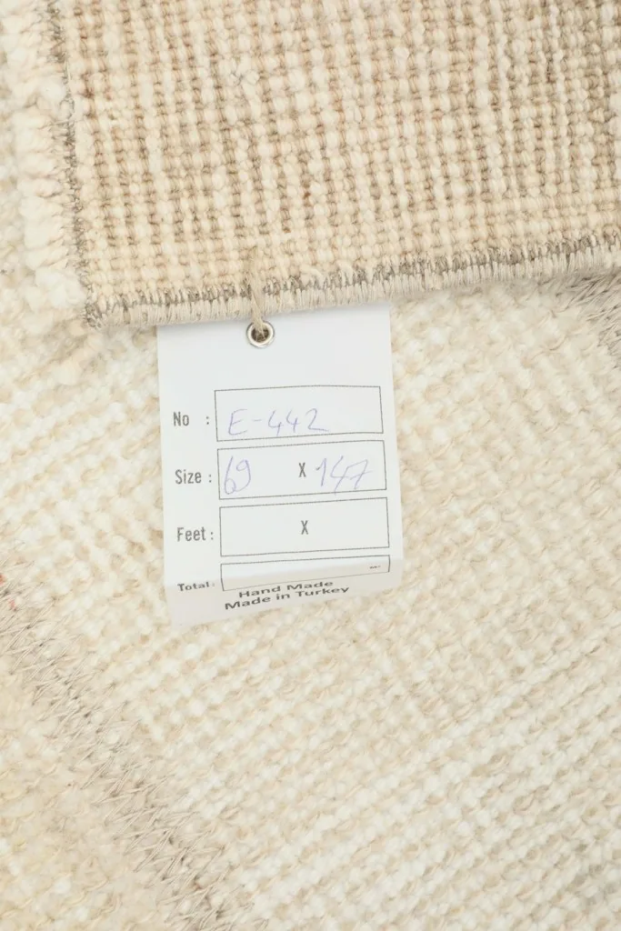 Close-up of the rug's label, indicating hand-knotted origin from Turkey