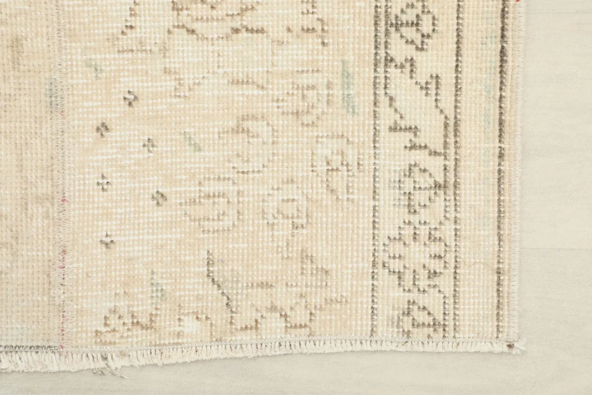 Close-up of the rug's border and fringe, showing the intricate details and finishing