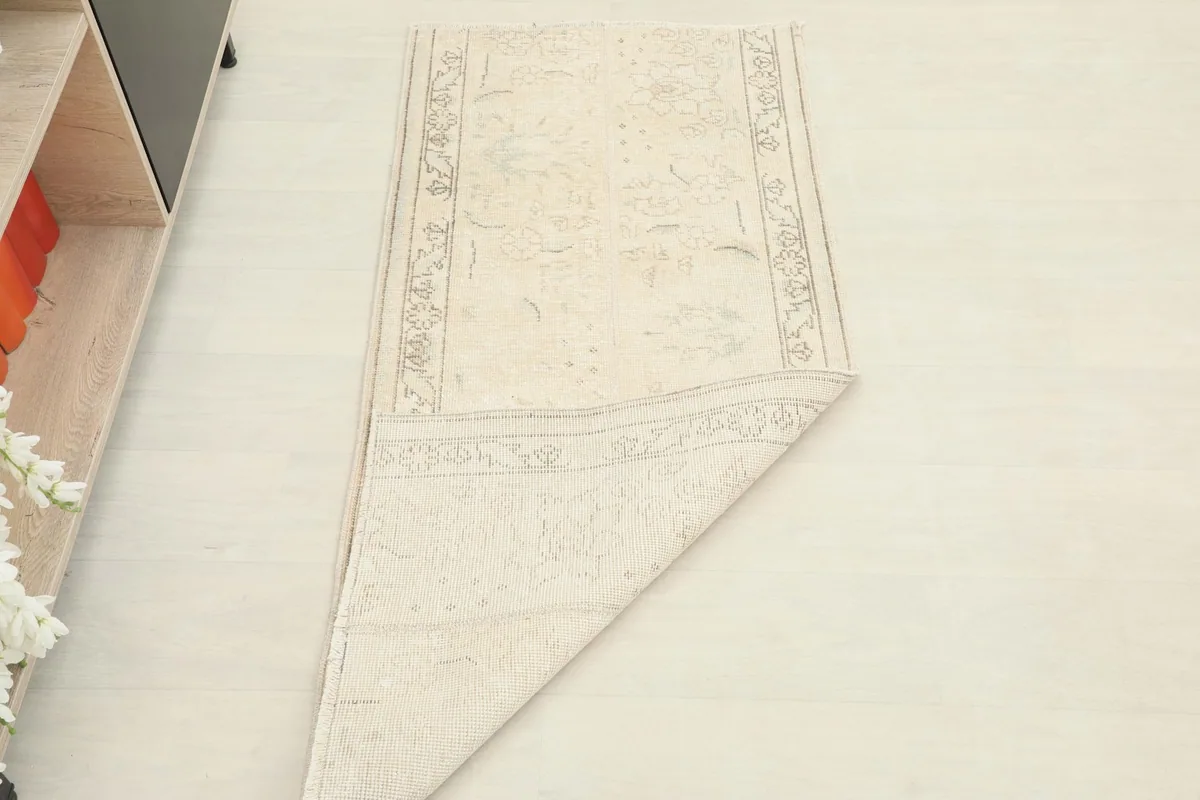 The rug partially folded, illustrating its flexibility and showing both top and bottom surfaces