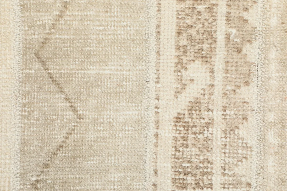 Very close-up of the hand-knotted wool pile, revealing the texture and specific geometric motifs.