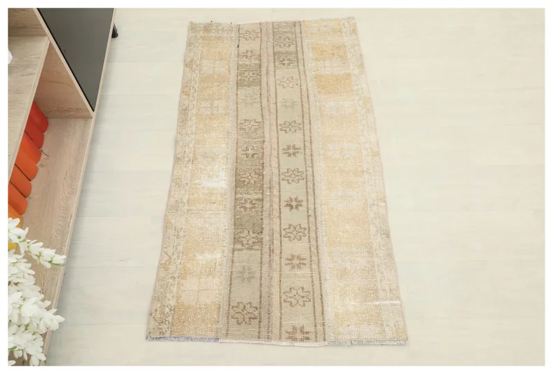 Full top view of the beige and brown striped vintage Anatolian rug on a white background