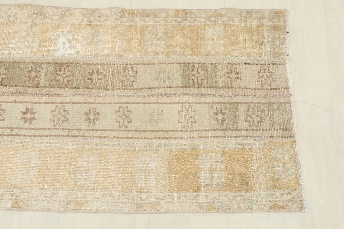 Close-up view of the rug's center, highlighting the beige, tan, and brown striped motifs