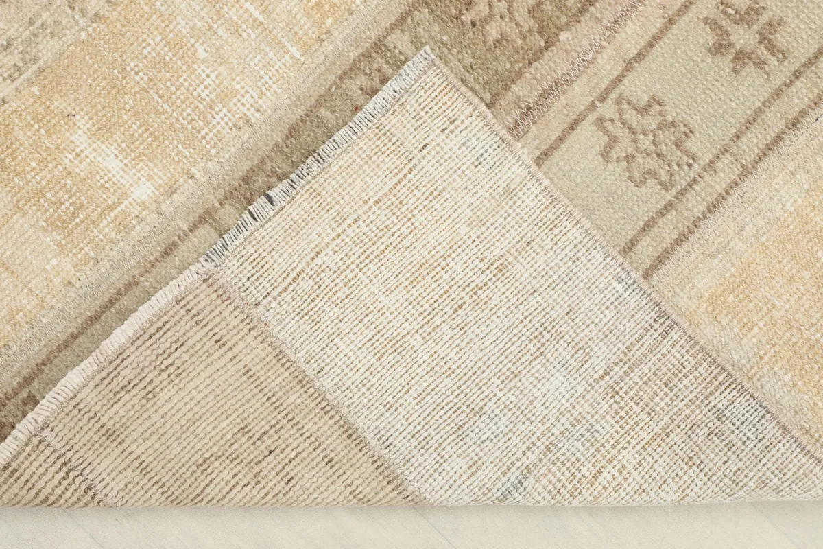 View of the back of the rug, revealing the cotton foundation and knotting structure