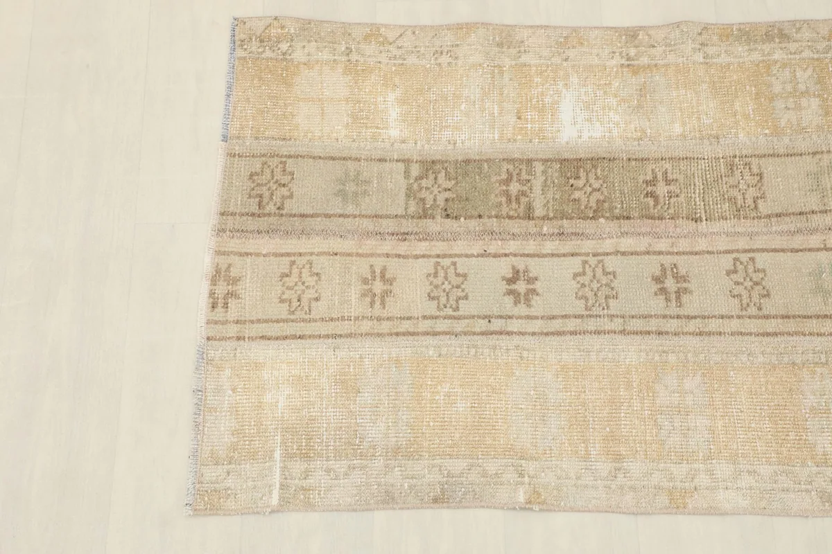 Overhead shot focusing on the upper half of the rug, detailing the geometric patterns