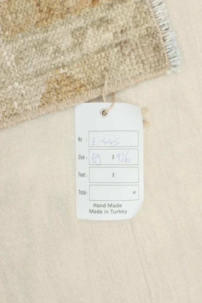 Close-up of the product tag indicating the rug's dimensions and 'Hand Made Made in Turkey'