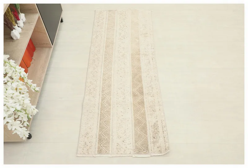 Full top view of the beige and tan striped geometric runner on a white background.