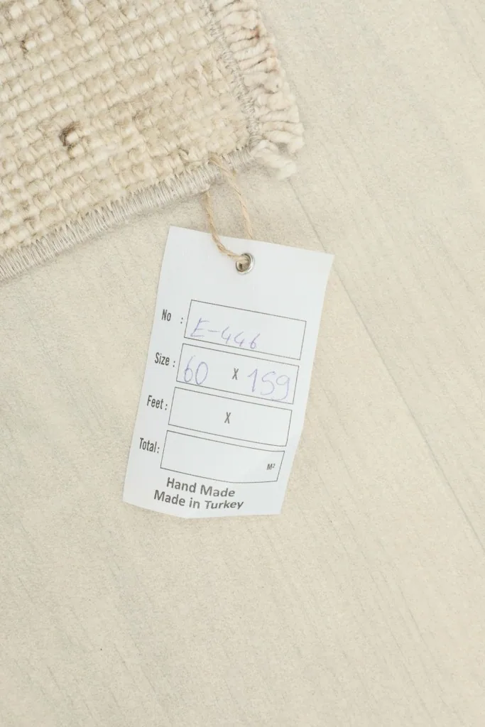 Close-up of the product tag indicating the rug's size and origin from Turkey.