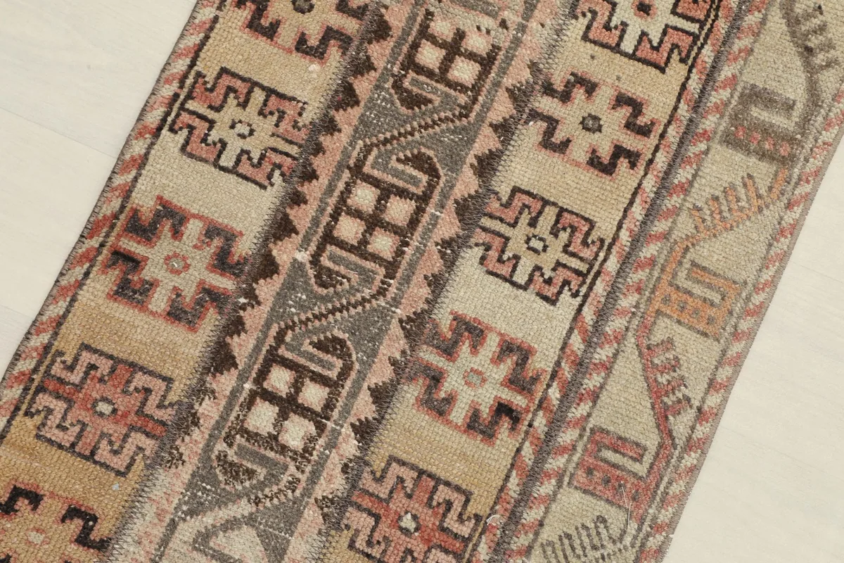 Angled view of the rug, emphasizing the varied geometric motifs across its surface