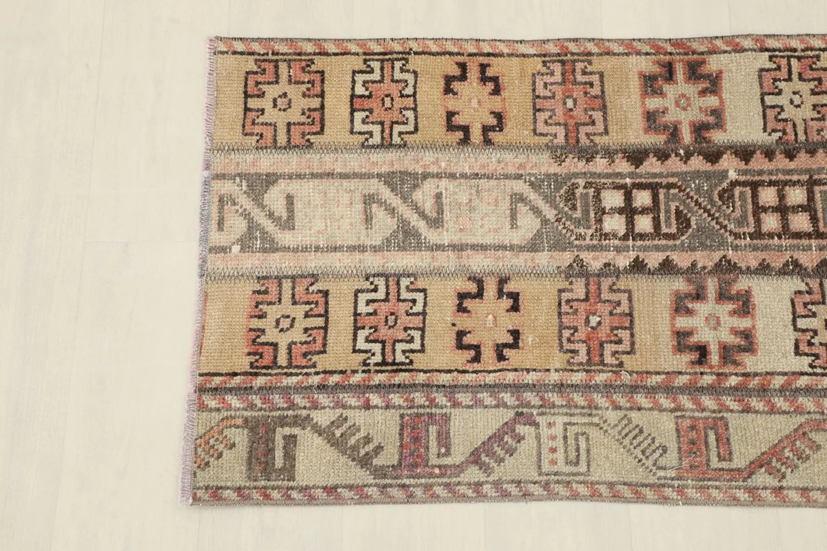 Detailed view of the rug's patterns and colors, showing the hand-knotted wool texture