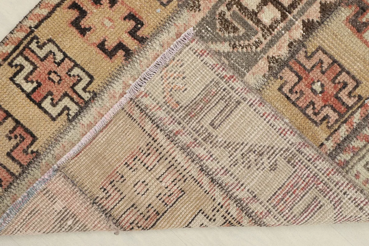 View of the rug's back, revealing the cotton foundation and fine hand-knotted construction
