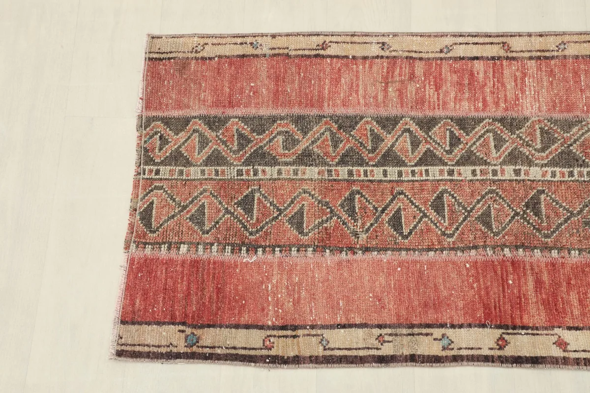 Detail view of the central tribal pattern, featuring interlocking shapes and varied color tones.