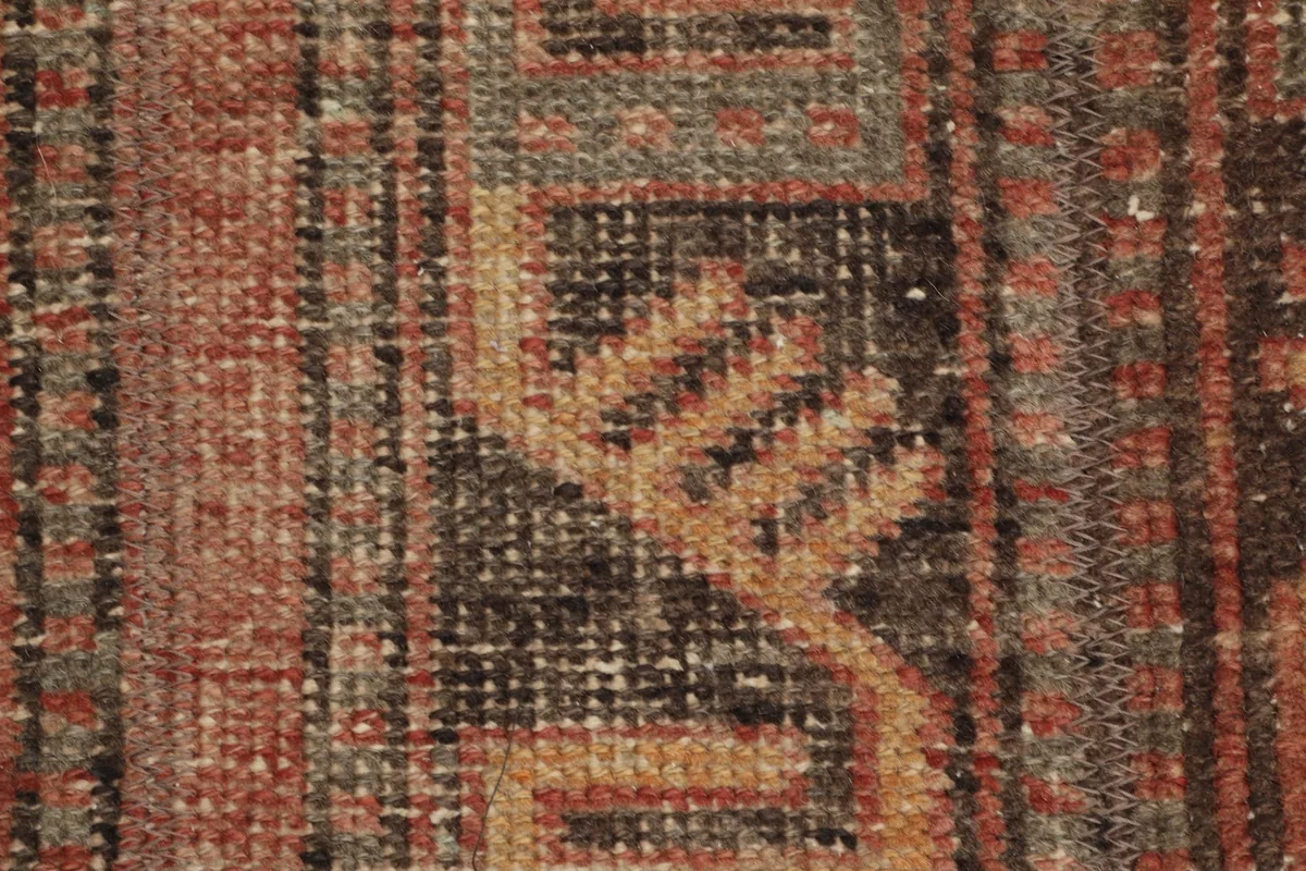 Close-up of the low wool pile, revealing the hand-knotted texture and fiber detail.