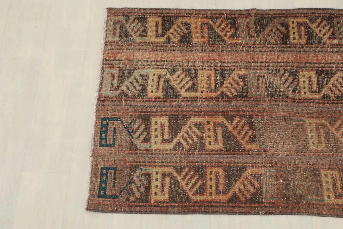 Overhead view of the rug's lower half, showing the distinct tribal patterns and color transitions.