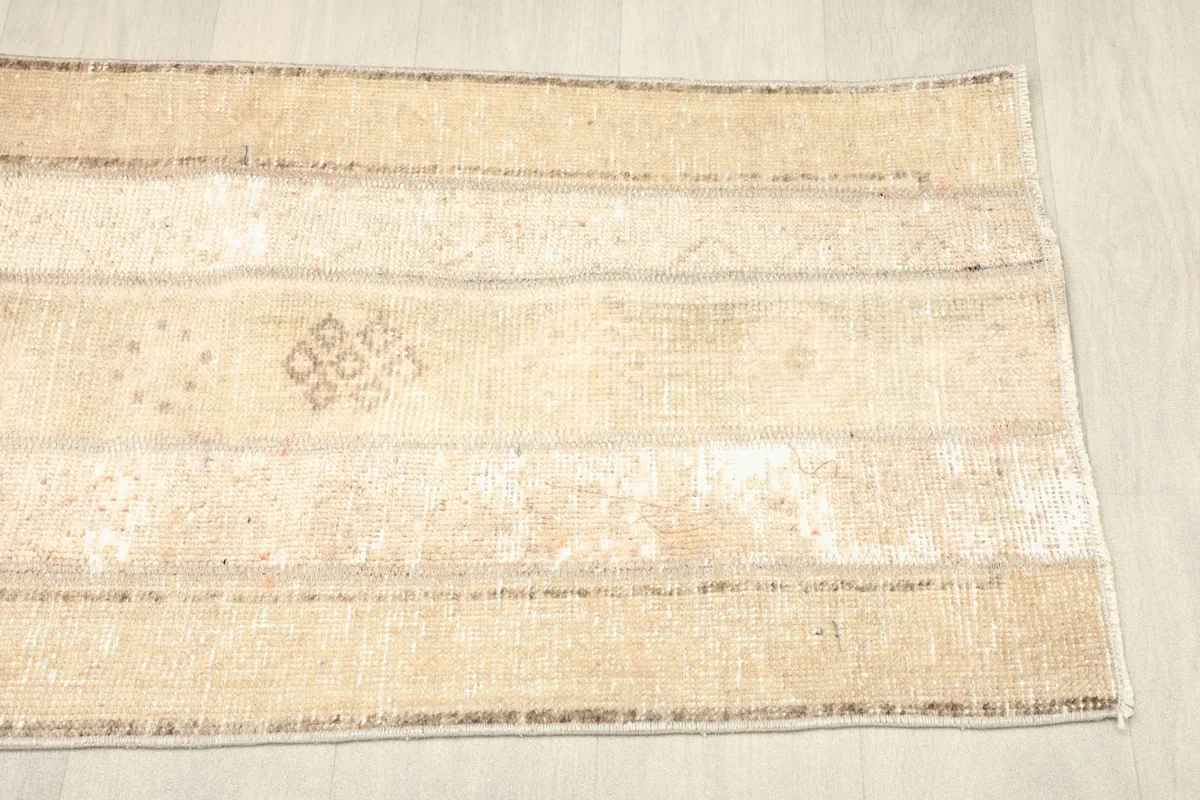 Another angled view, focusing on the overall striped design and distressed texture of the rug.
