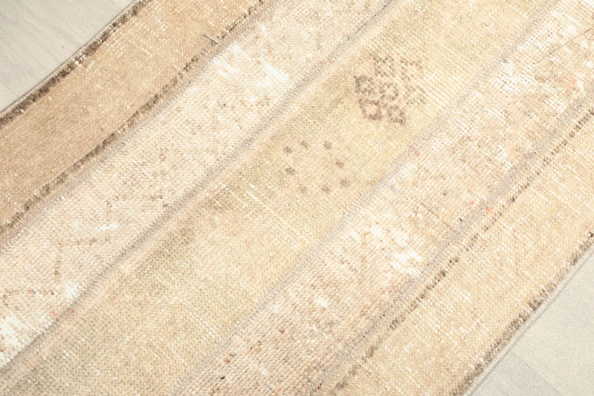 Angled close-up highlighting the subtle geometric patterns within the beige and tan stripes.